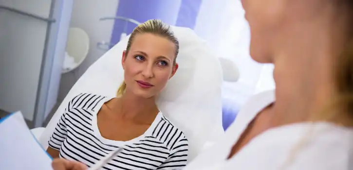 Guía rápida para tu equipo de marketing de clínica: cómo vender tratamientos con LASEmaR 1500 1 Doctora explicando el tratamiento estético a la paciente recostada en la silla de la clínica